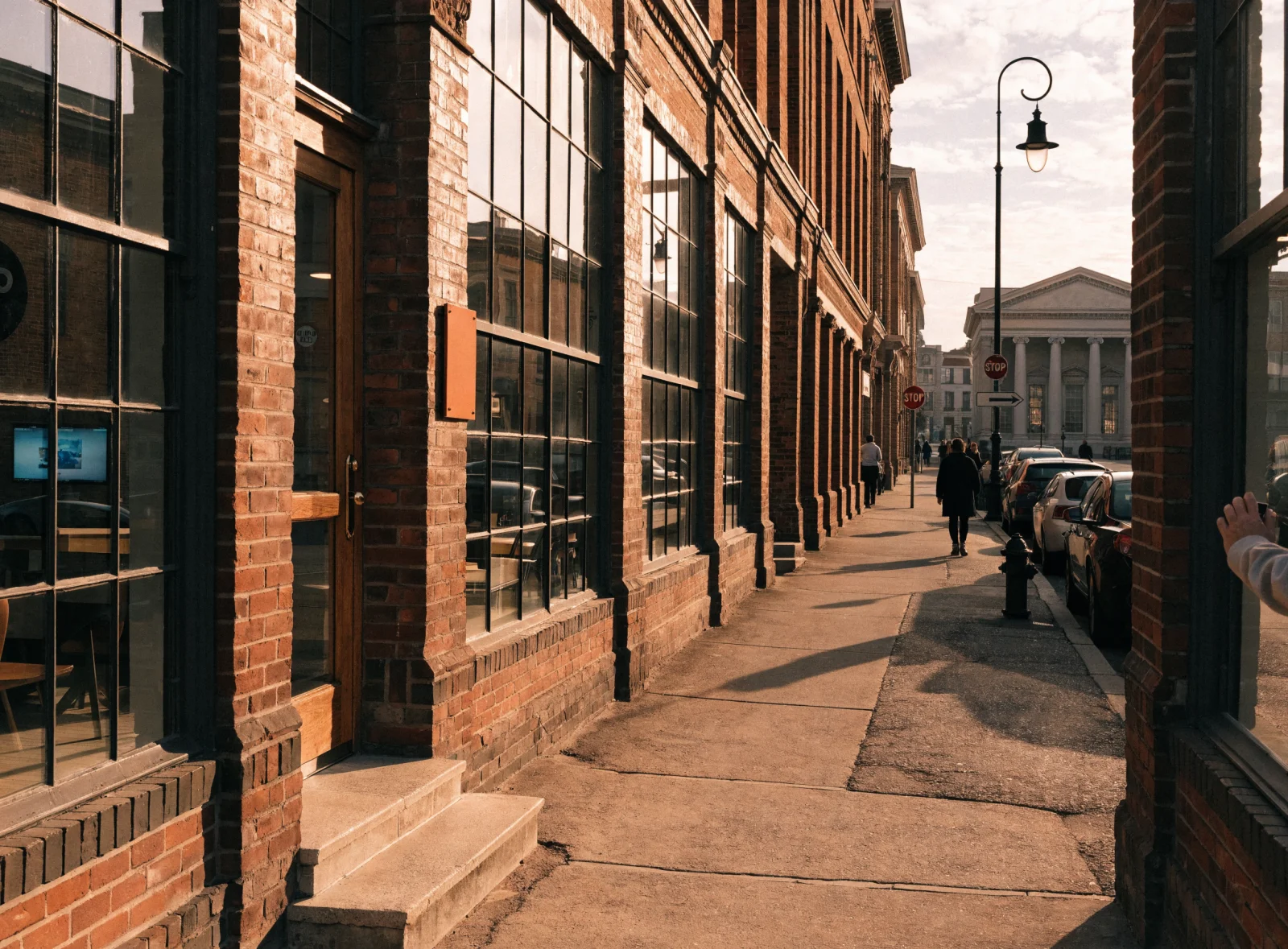 A downtown street of brick law offices leading to a columned courthouse